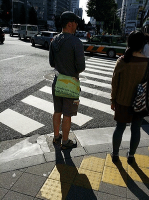 Một thanh niên người nước ngoài nổi bật với chiếc túi thời trang lạ lẫm